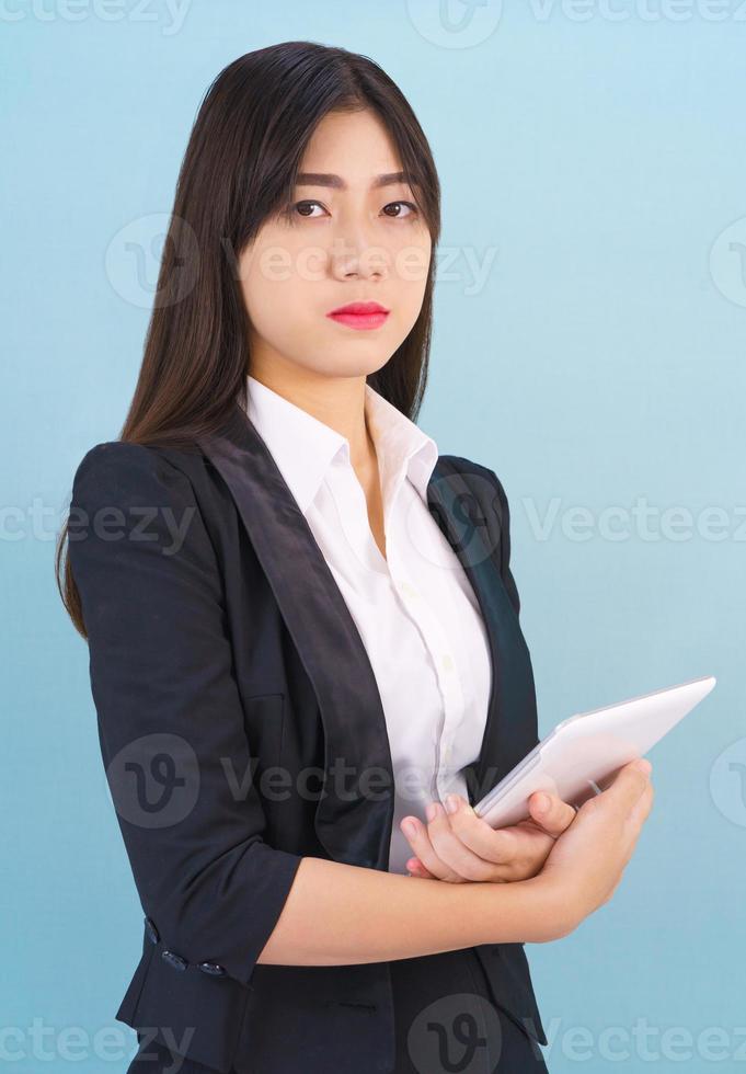 Women standing in suit holding digital tablet photo