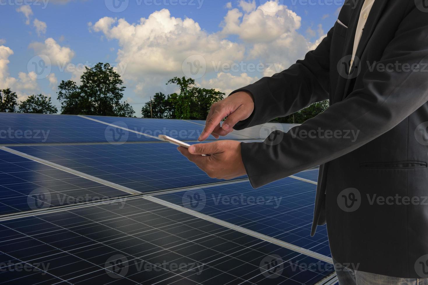 Photovoltaic technology, service engineers inspecting solar cell installations. photo