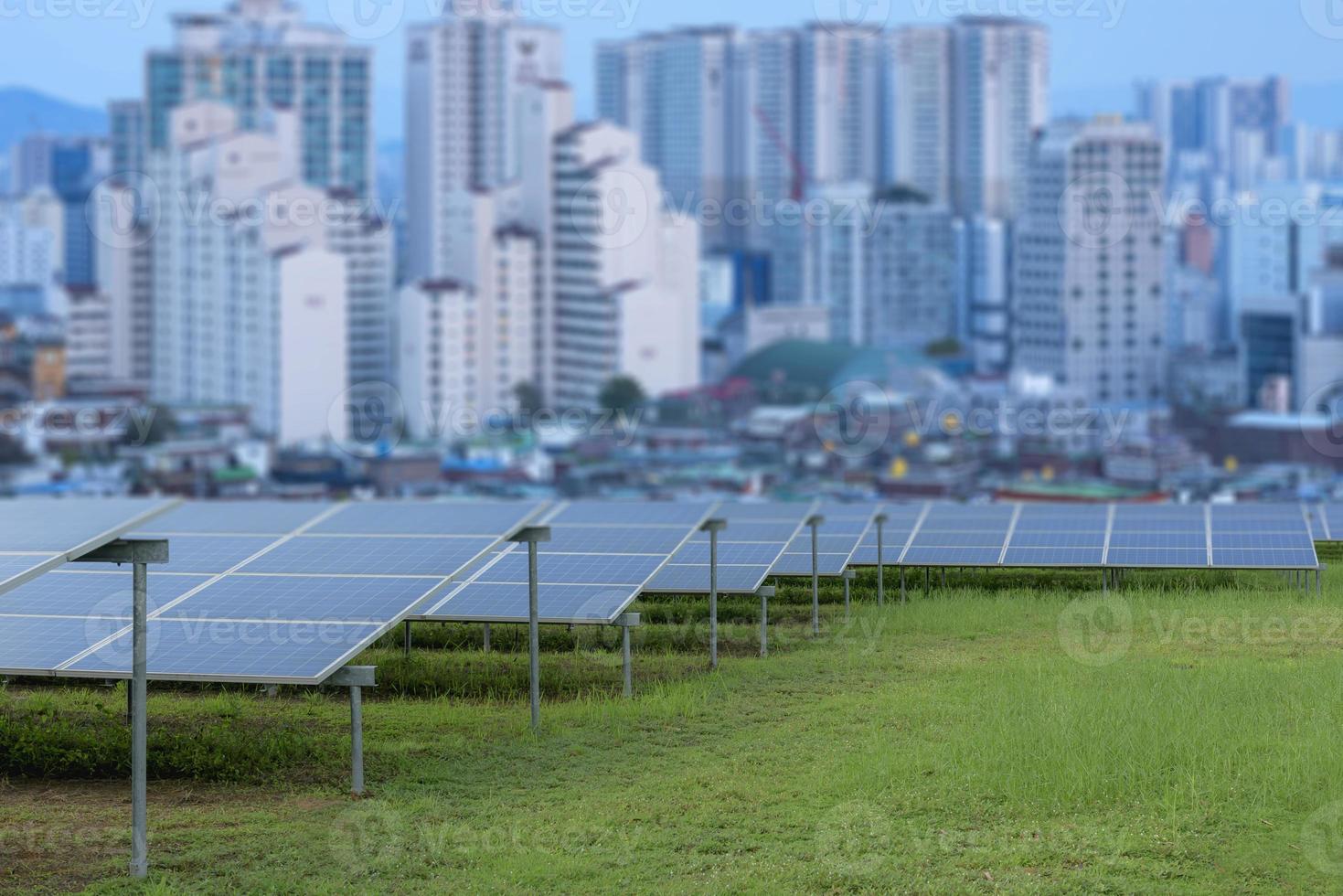 Power plant using renewable solar energy with city building background. photo