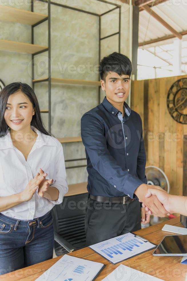Two confident businessman shook hands during office meetings. photo