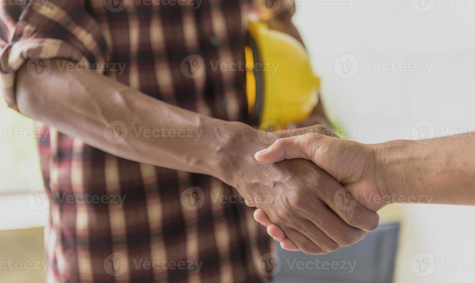 Businessmen join hands to invest and share profits in real estate projects. photo