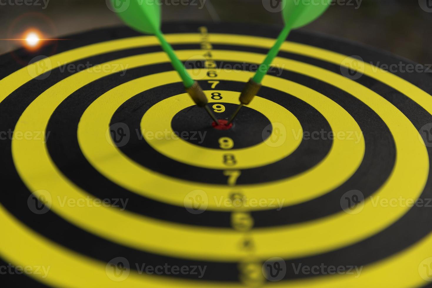 Two dart hit it's target on a red background, concept for success,darts motion blur. photo