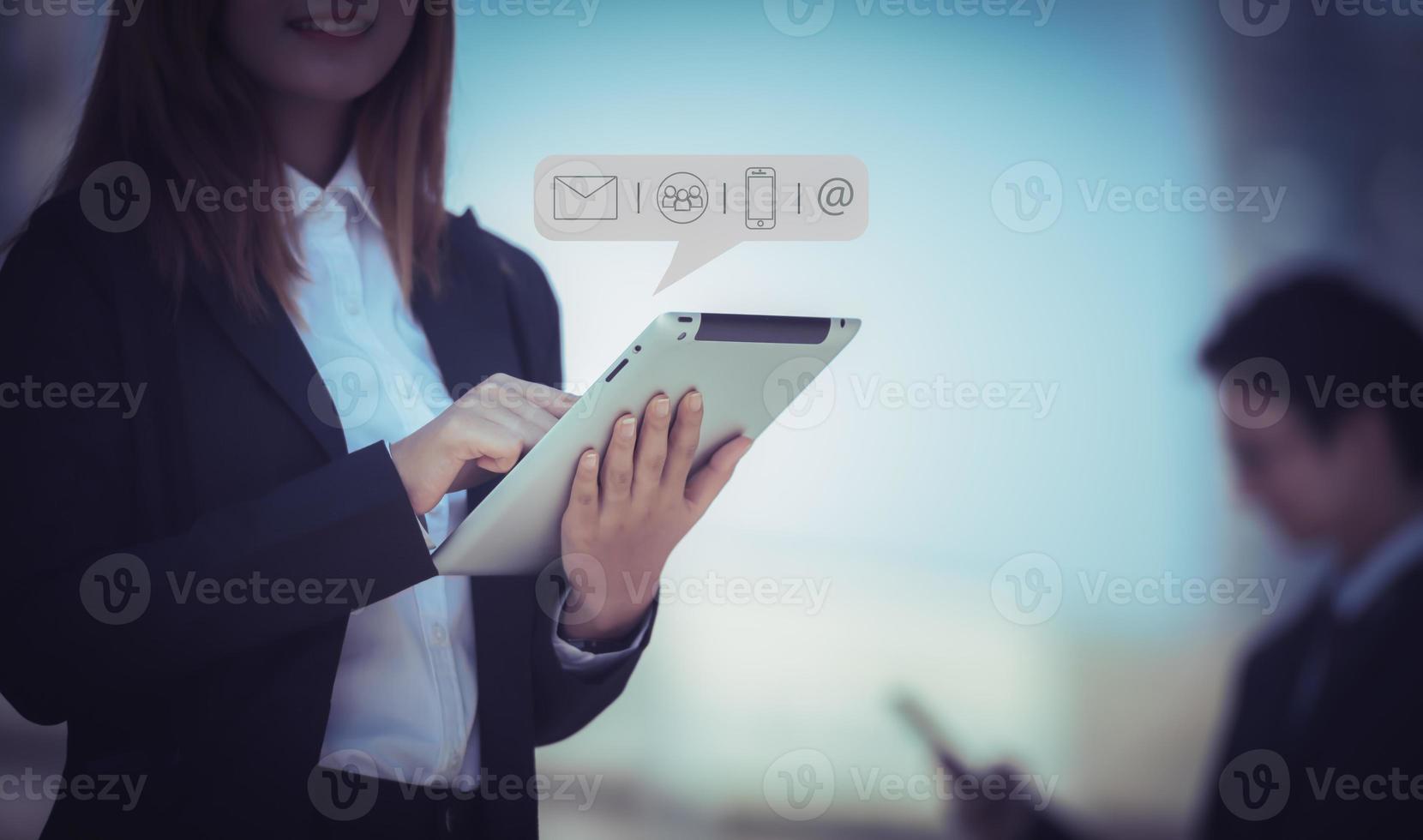 Hands of business woman typing on tablet computer with communication contact icon, E-mail, Phone number, Social media group. photo