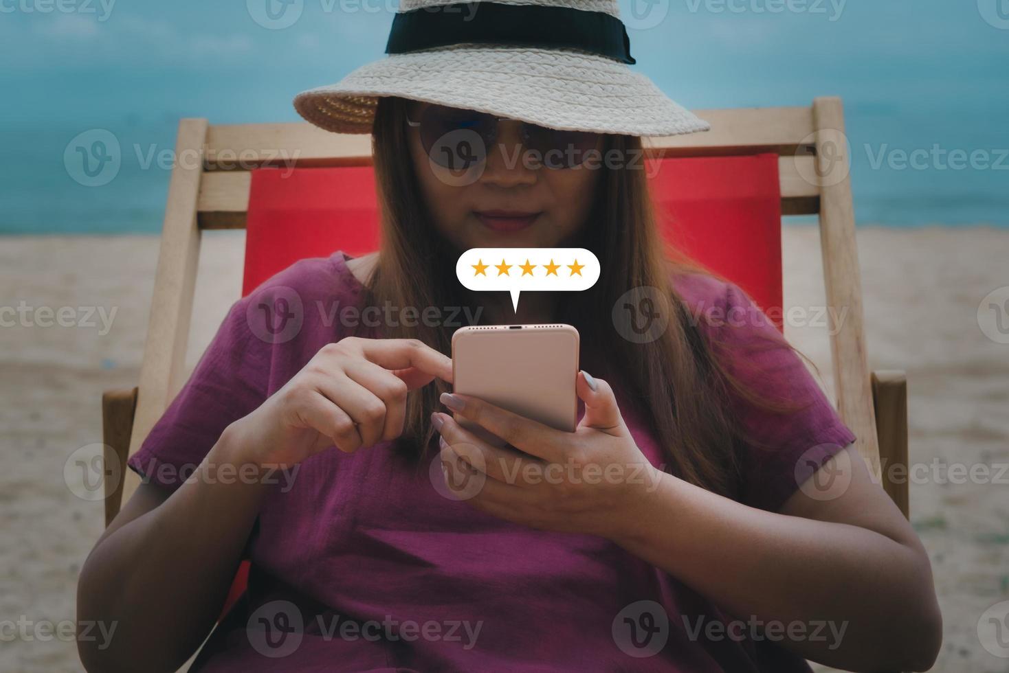 Young woman hand using smartphone with popup five star icon for feedback review satisfaction service, Customer service experience and business satisfaction survey concept. photo