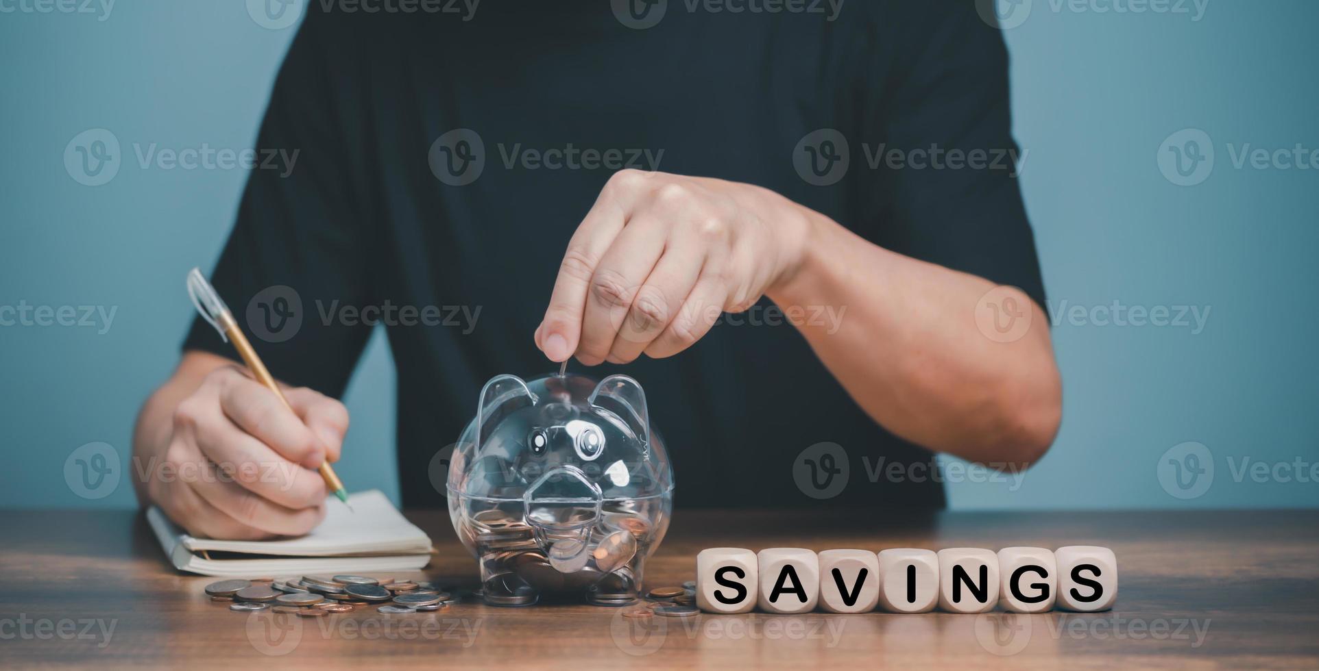 Family financial savings planning, Man hand holding piggy bank on wood table, saving money wealth and financial concept, Business, finance, investment, Financial planning. photo