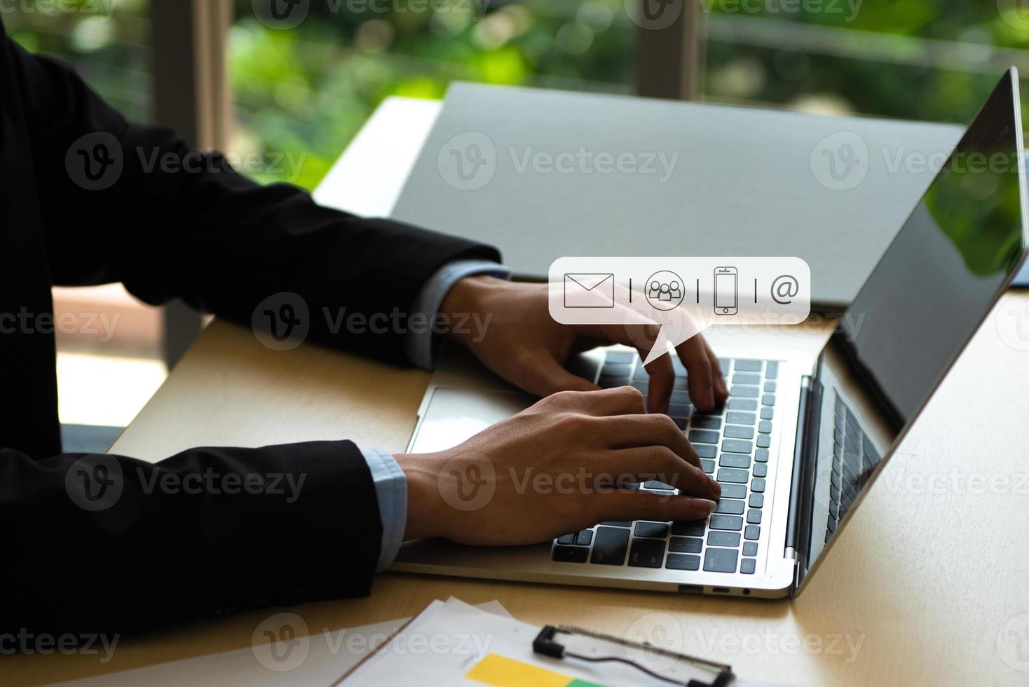 Business Contact Us concept, Hands typing on keyboard computer with communication contact icon, E-mail, Phone number, Social media chatting message. photo