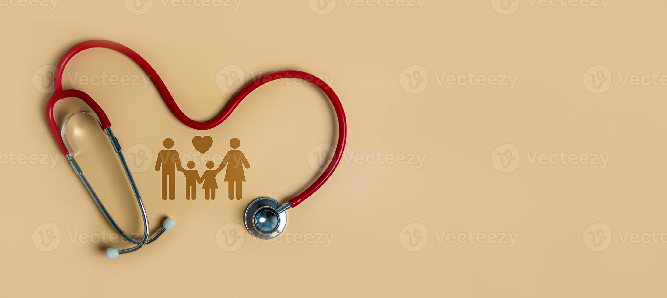 Top view of medical stethoscope and icon family on light orange background. Family health care insurance concept. photo