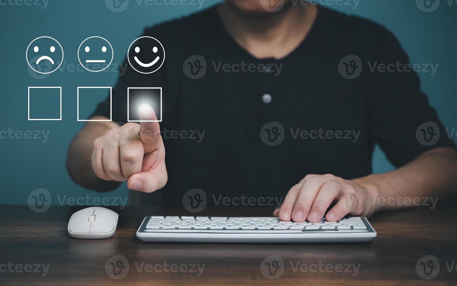 Customer service and satisfaction concept ,Business people using computer and touching the virtual screen on the happy Smiley face icon to give satisfaction in service. rating very impressed. photo