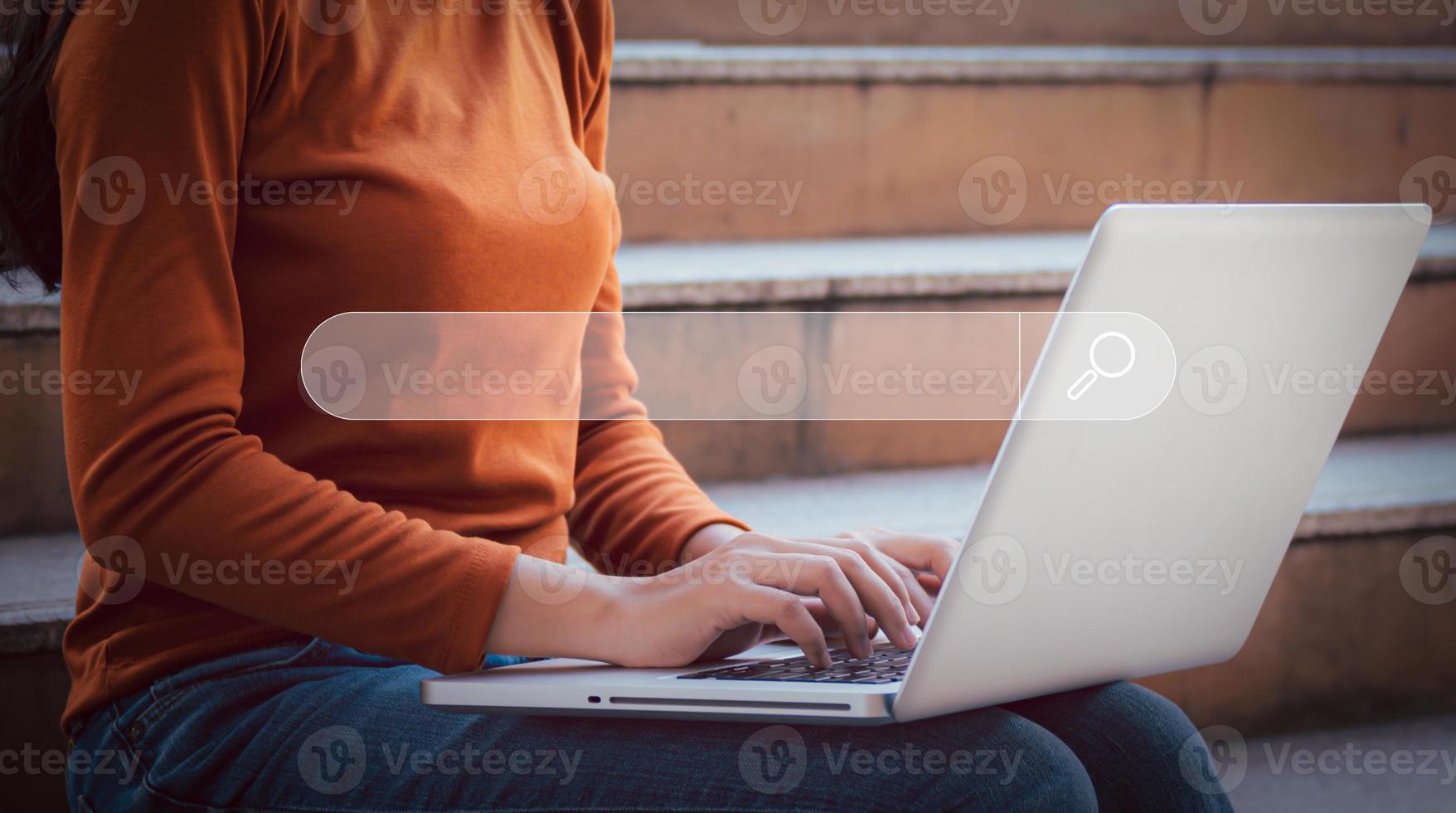 Young woman leaning and using computer searching research information by written in search bar or search box on virtual screen, browsing Internet global data Information, technology learning concept. photo