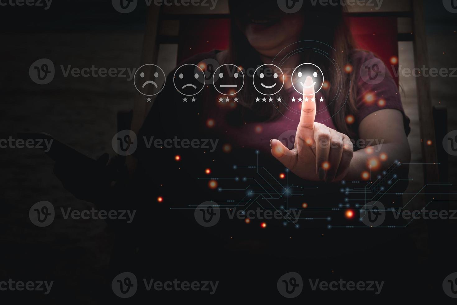 Young Business woman pressing smiling face emoticon on virtual touch screen. Customer service evaluation  and rating concept. photo