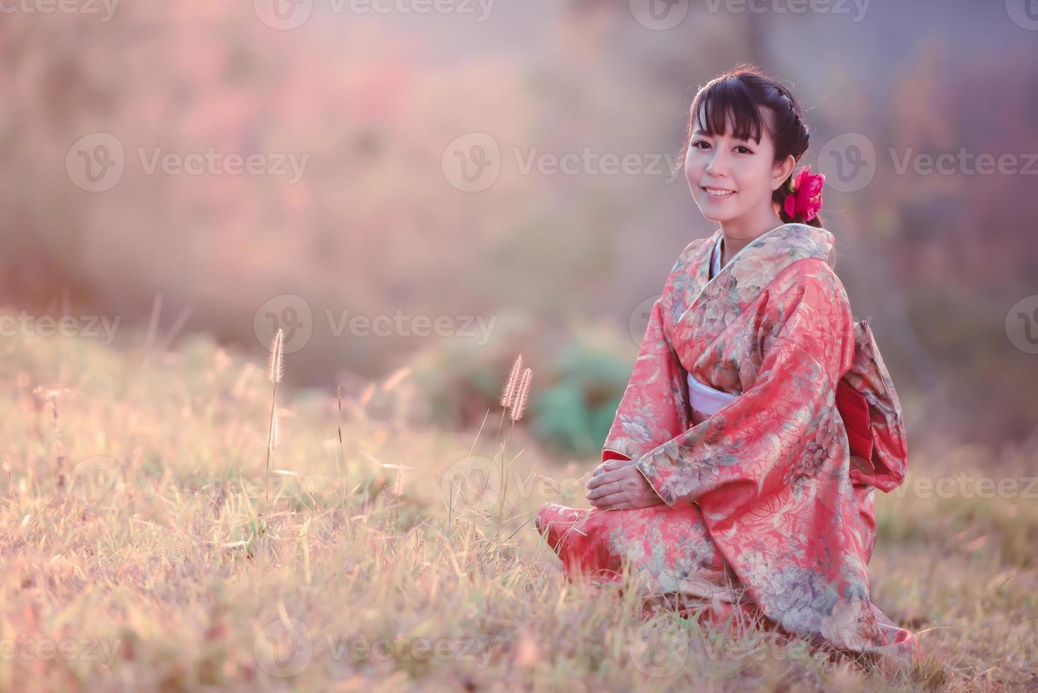 viajes, concepto de vacaciones en Japón, joven asiática con kimono japonés tradicional en el parque por la mañana. foto