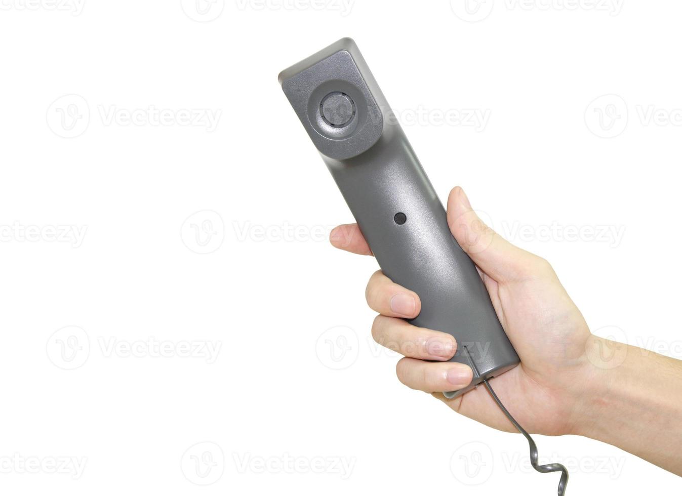 Hand holding telephone receiver isolated over white background photo