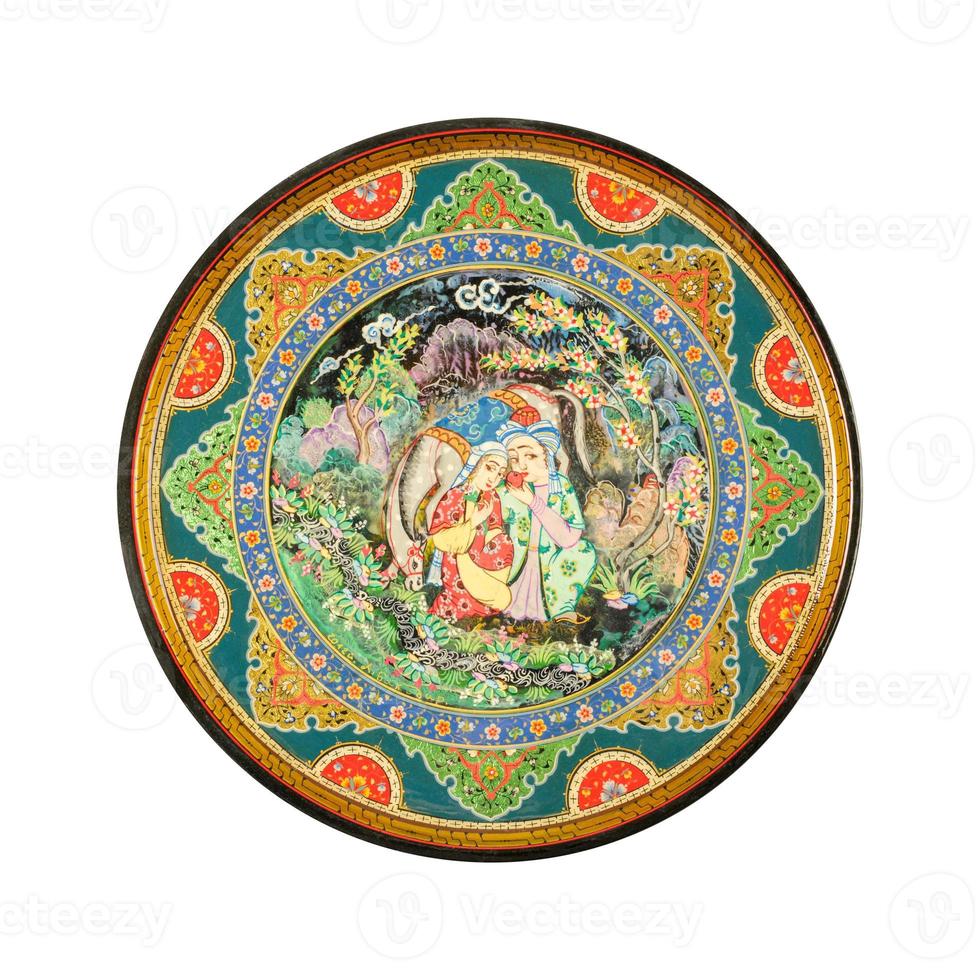 A top view of an oriental ceramic plate with a painting of a couple on a white background, Uzbekistan photo