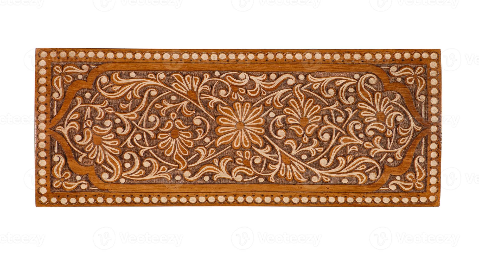 A wooden carved ornament isolated on a white background photo