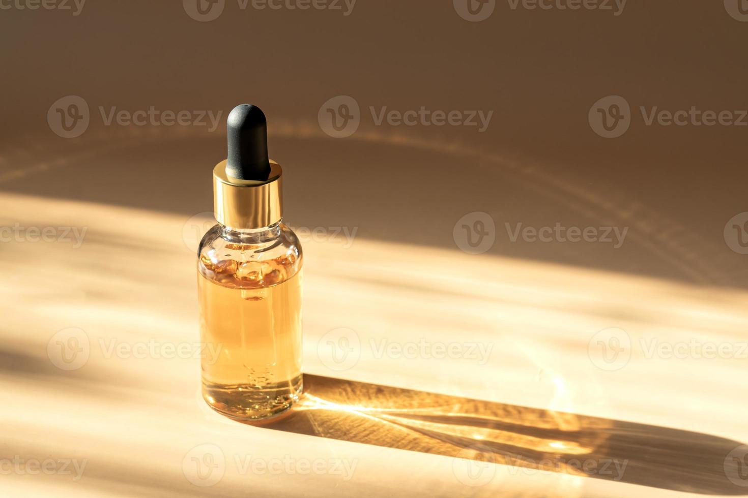 Transparent cosmetic bottle with pipette on beige background lit by the sun, product packaging, anti aging serum with peptides, cosmetics mockup, spa concept photo