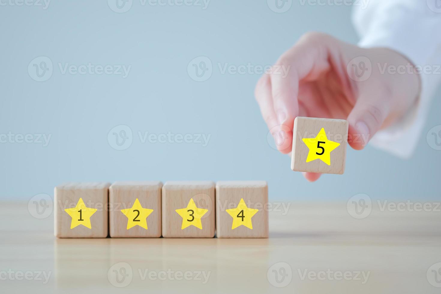 Evaluation, Satisfaction, Feedback, Review concept. Hand holding star with 5 number on wooden block with Excellent on speech bubble. The best excellent business services rating customer experience. photo