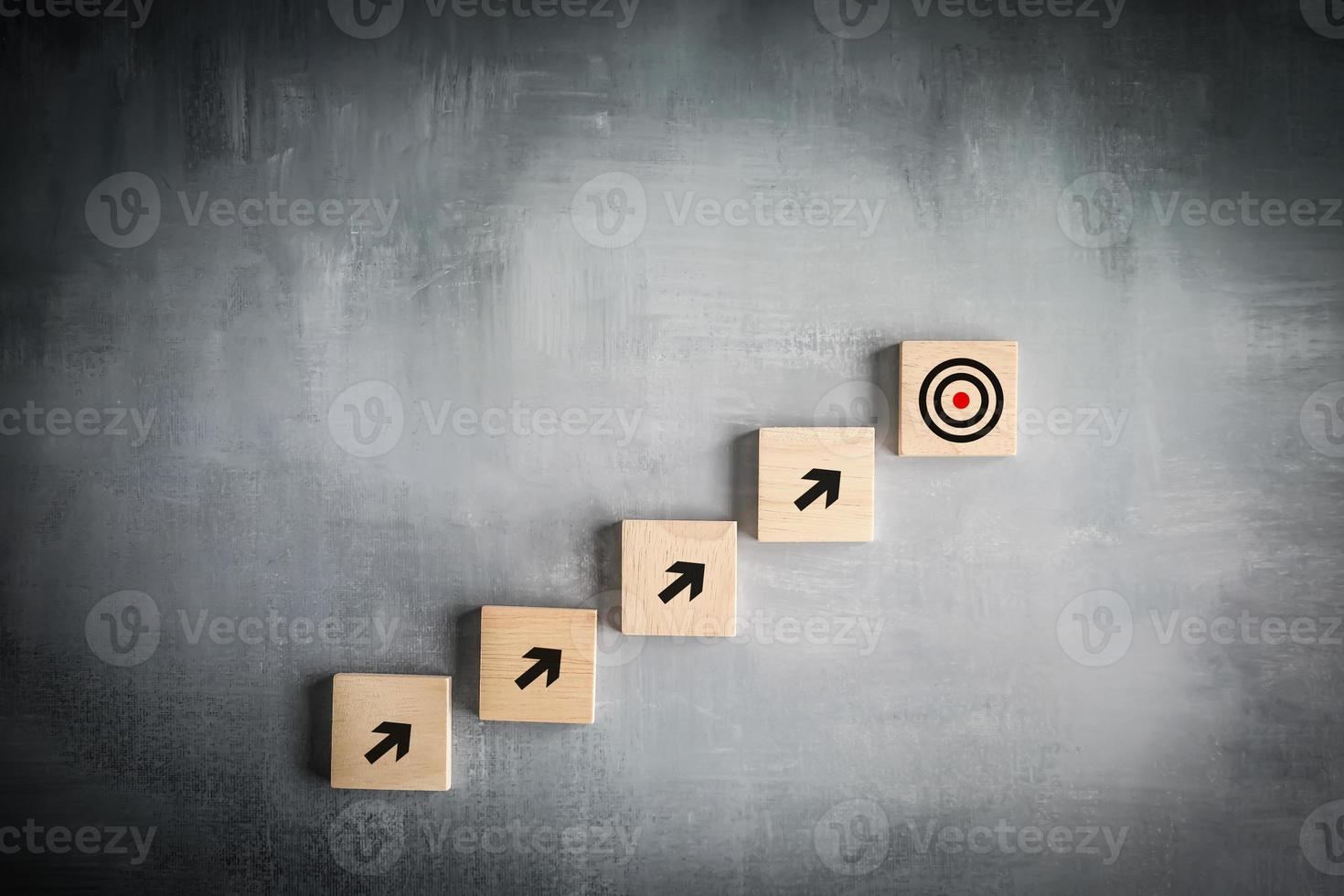 Challenge goal and target, Business achievement and objective target. Growing business success concept.  Arrow pointing to the dartboard target step by step. photo
