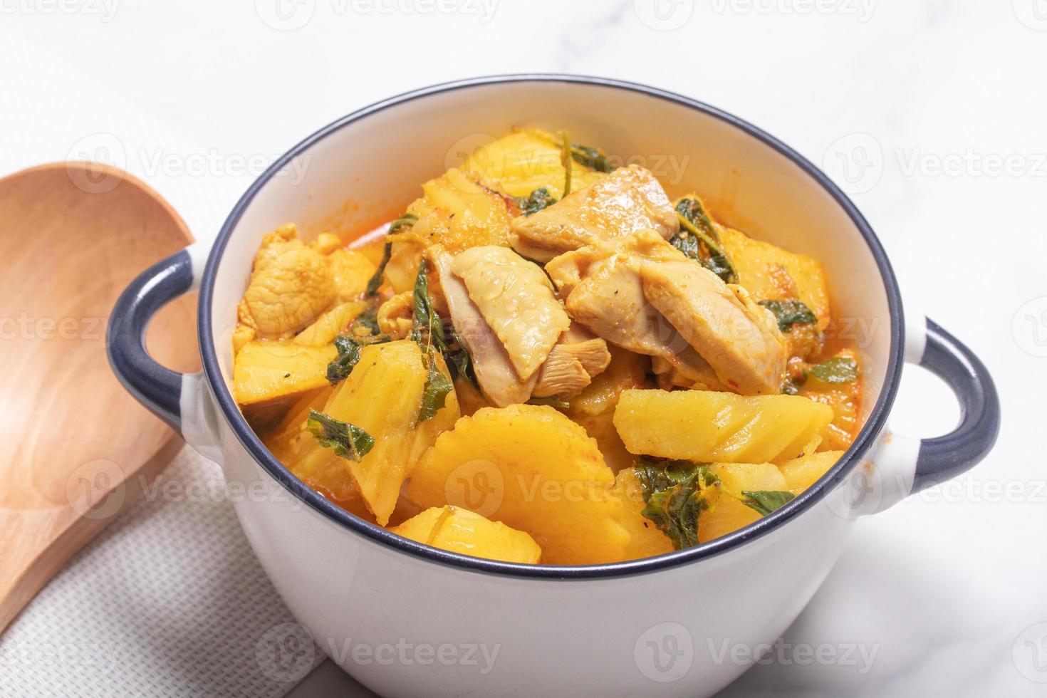 Chicken and Potato Curry with Basil Leaves in a Thai White Bowl photo