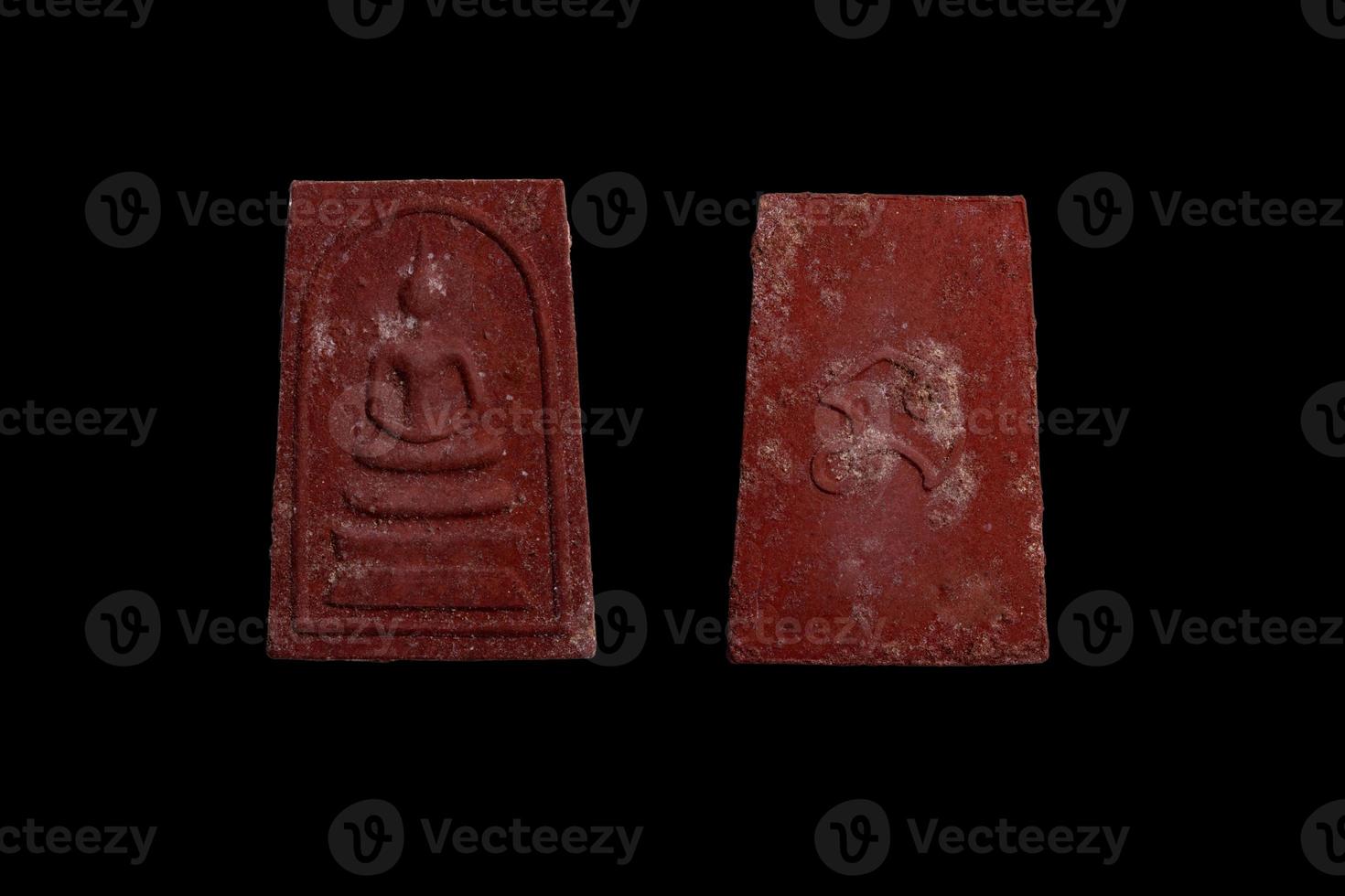 red brown amulet on black background photo