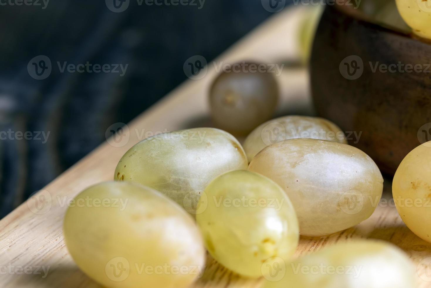 Homemade green unwashed grapes on a board photo