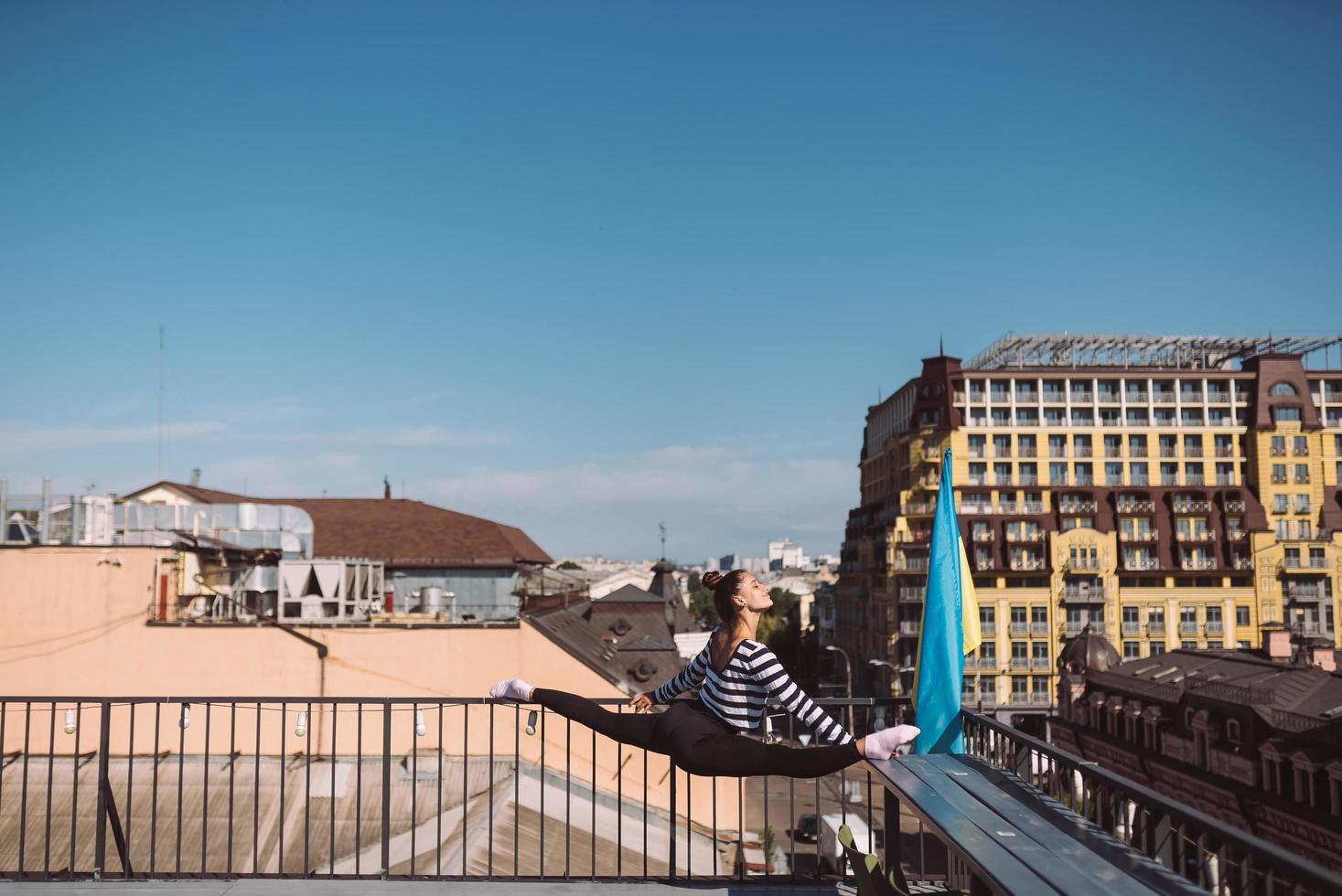 A young woman is doing twine on the roof of the house photo