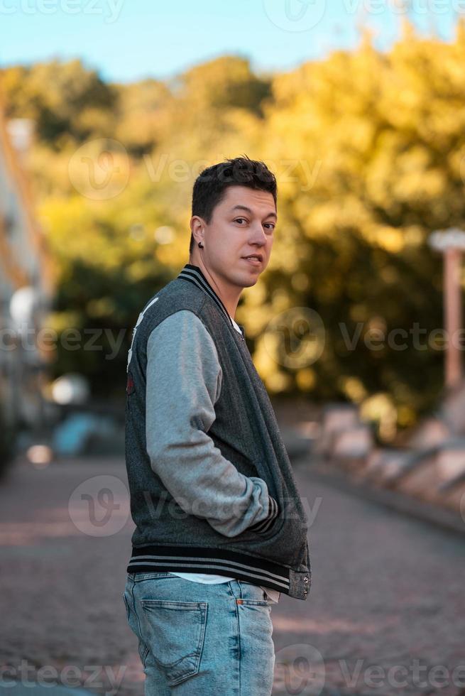 Picture of serious young man walking on the street photo