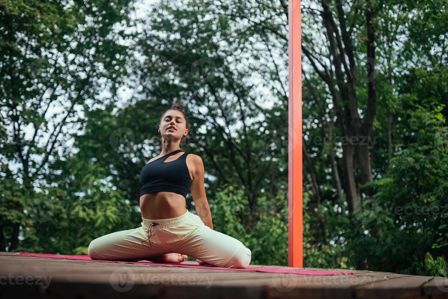 A young woman in doing yoga in the yard photo