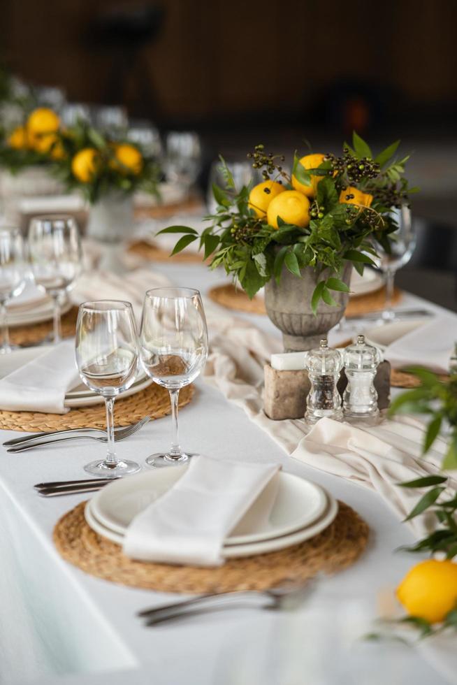 Festive table at the wedding party decorated with lemon arrangements photo