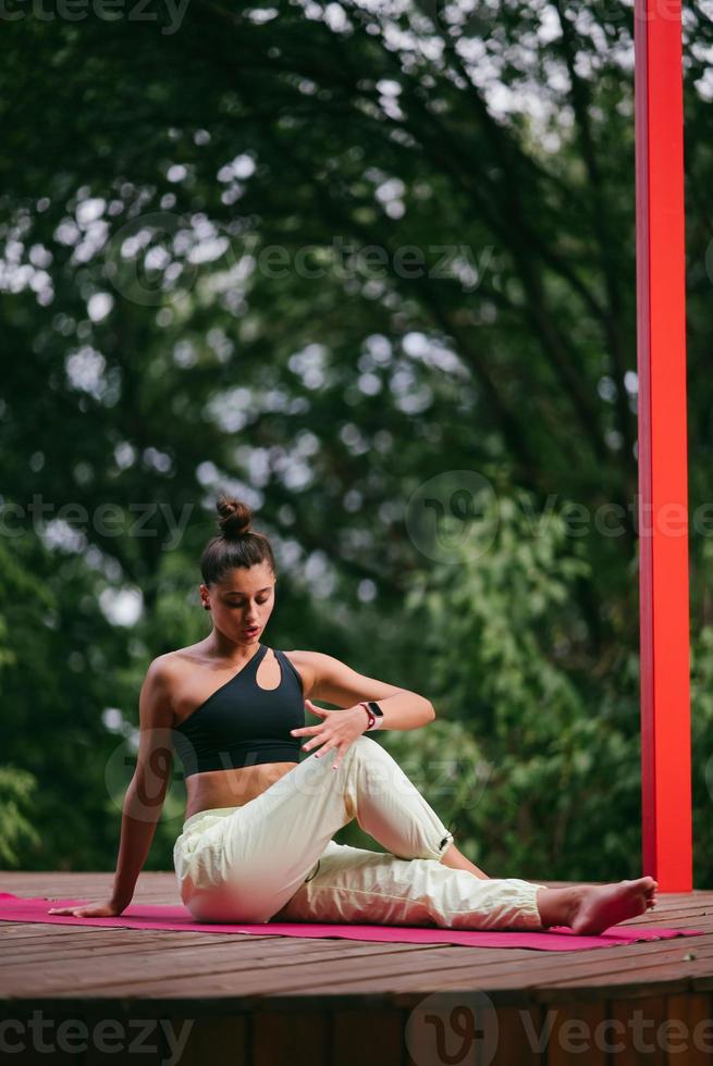 A young woman in doing yoga in the yard photo