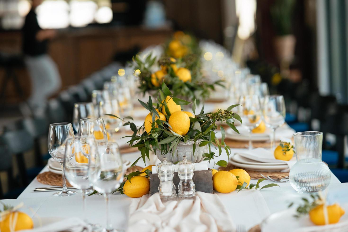Festive table at the wedding party decorated with lemon arrangements photo