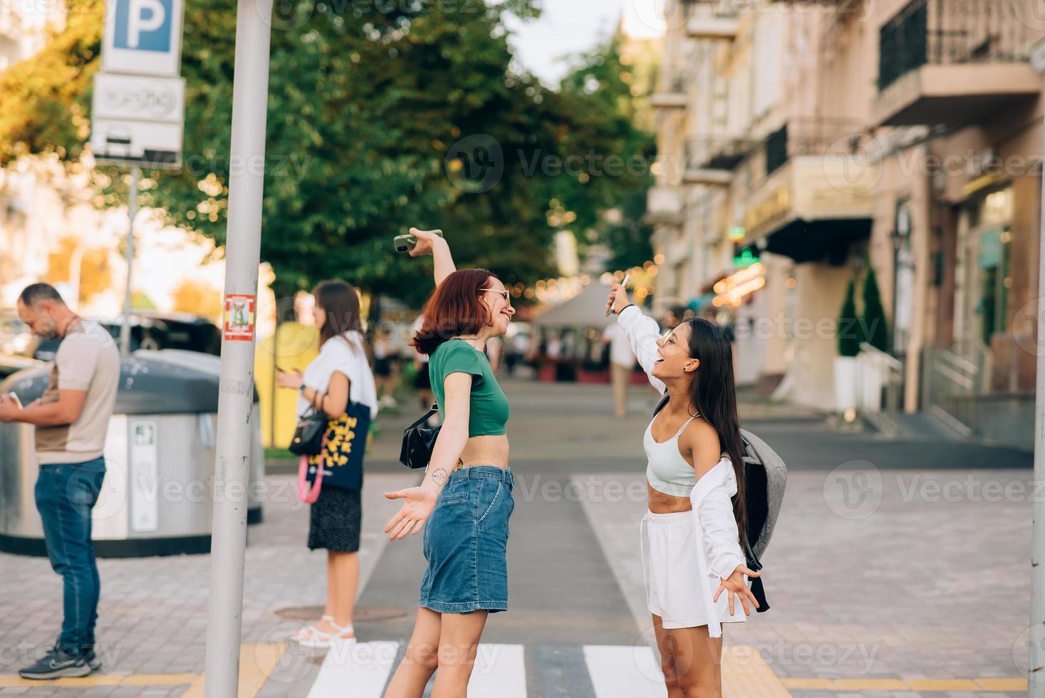 Happy meeting of two friends hugging in the street photo