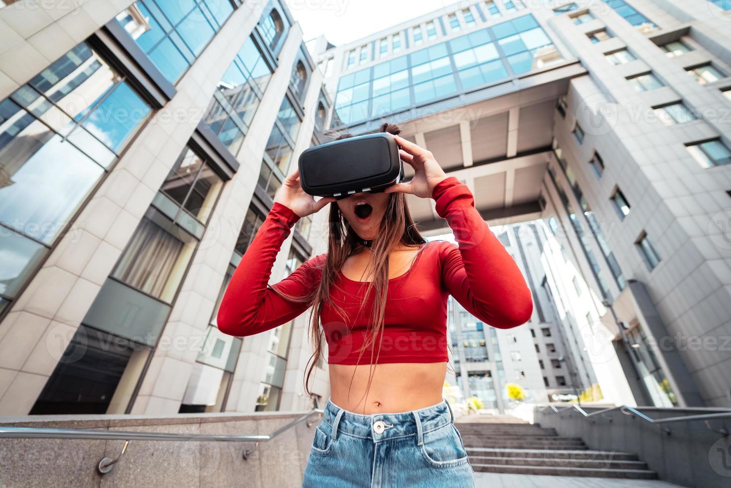 Woman in a virtual reality helmet walks down the street photo