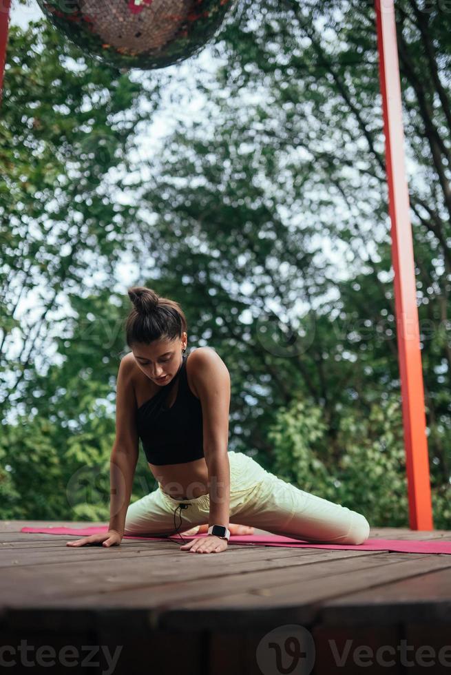 A young woman in doing yoga in the yard photo