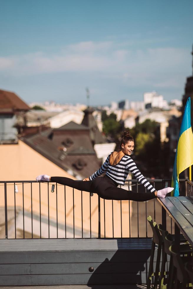 A young woman is doing twine on the roof of the house photo