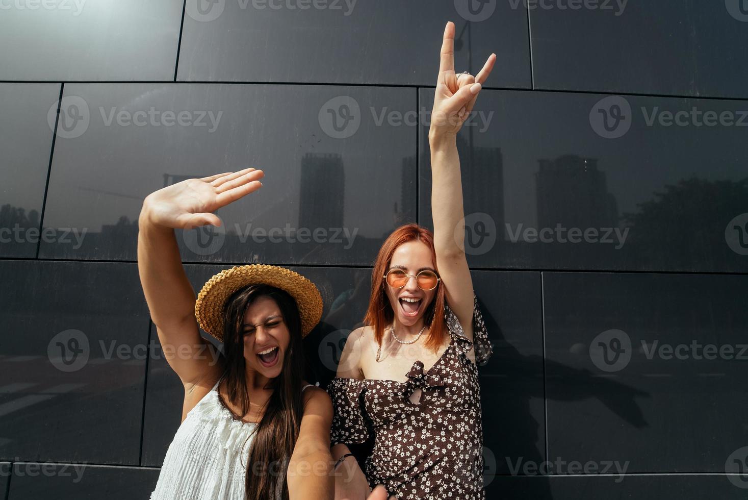 Two attractive young women fooling around in fresh air. photo