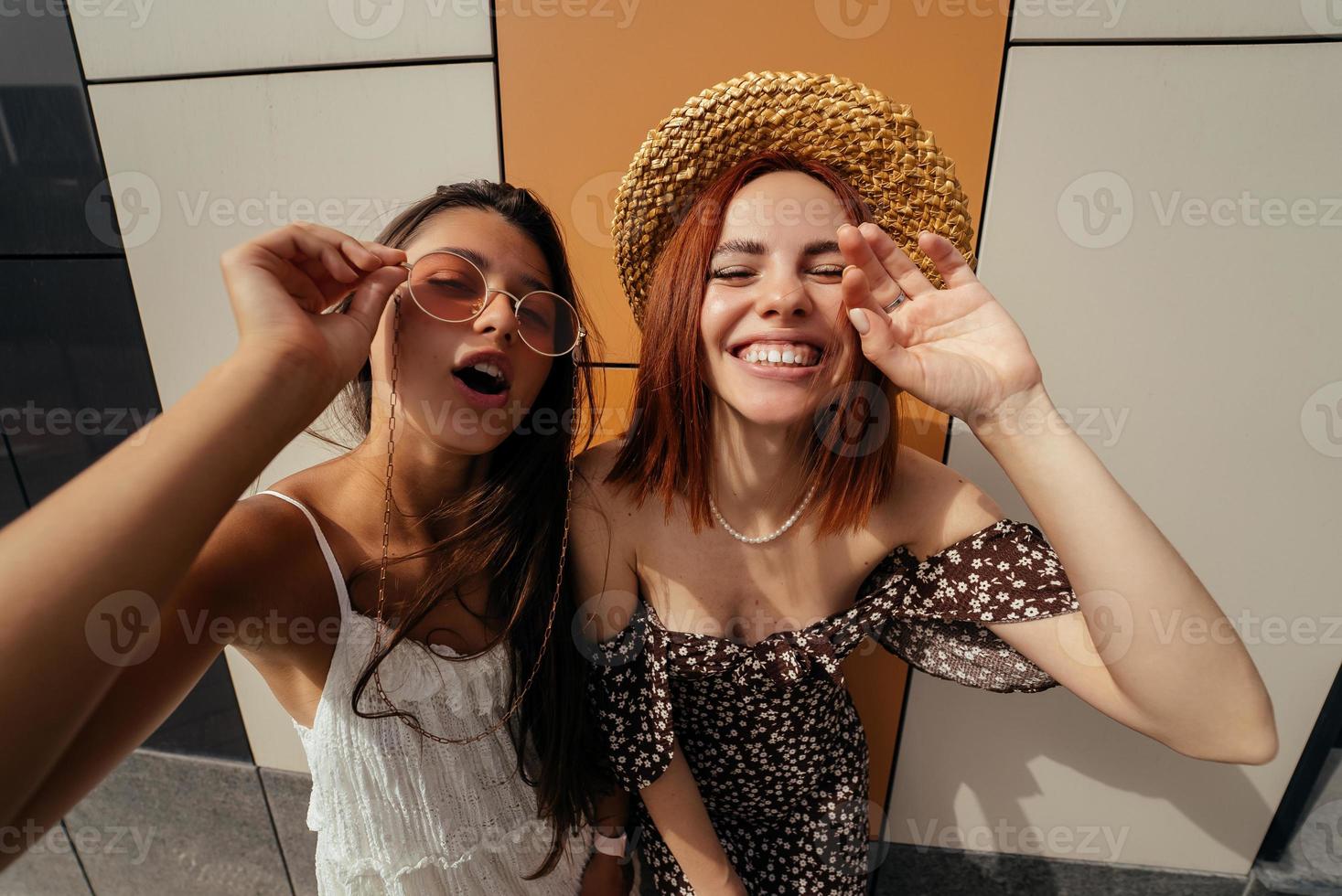 Two attractive young women fooling around in fresh air. photo