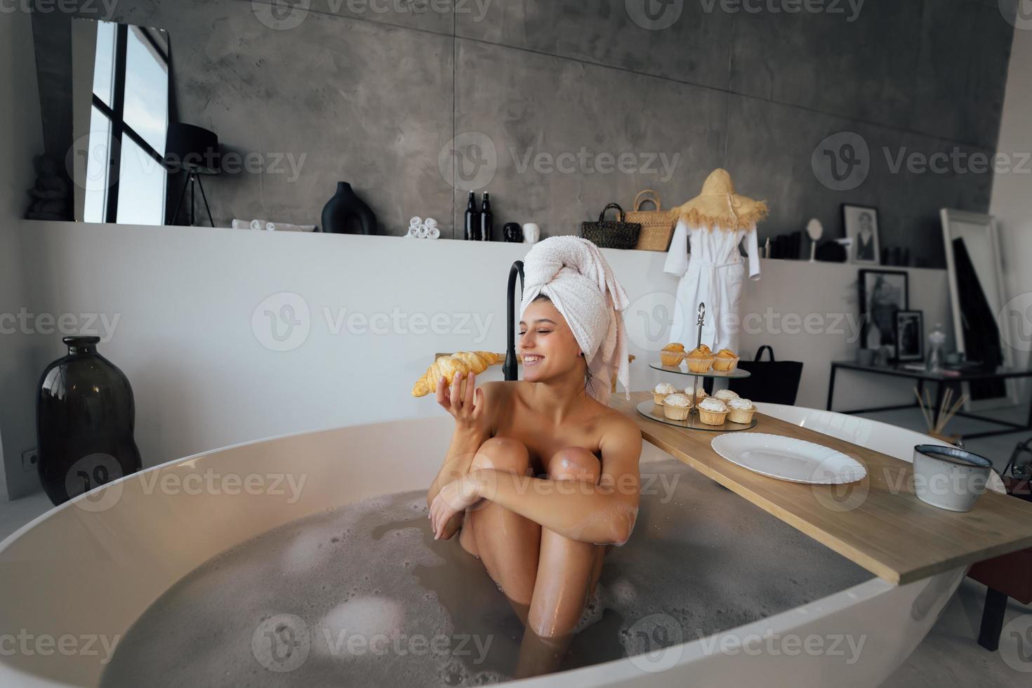 Luxury fashion woman in the morning take breakfast lying in bath photo