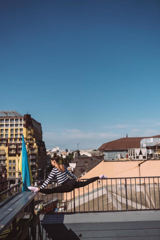 A young woman is doing twine on the roof of the house photo