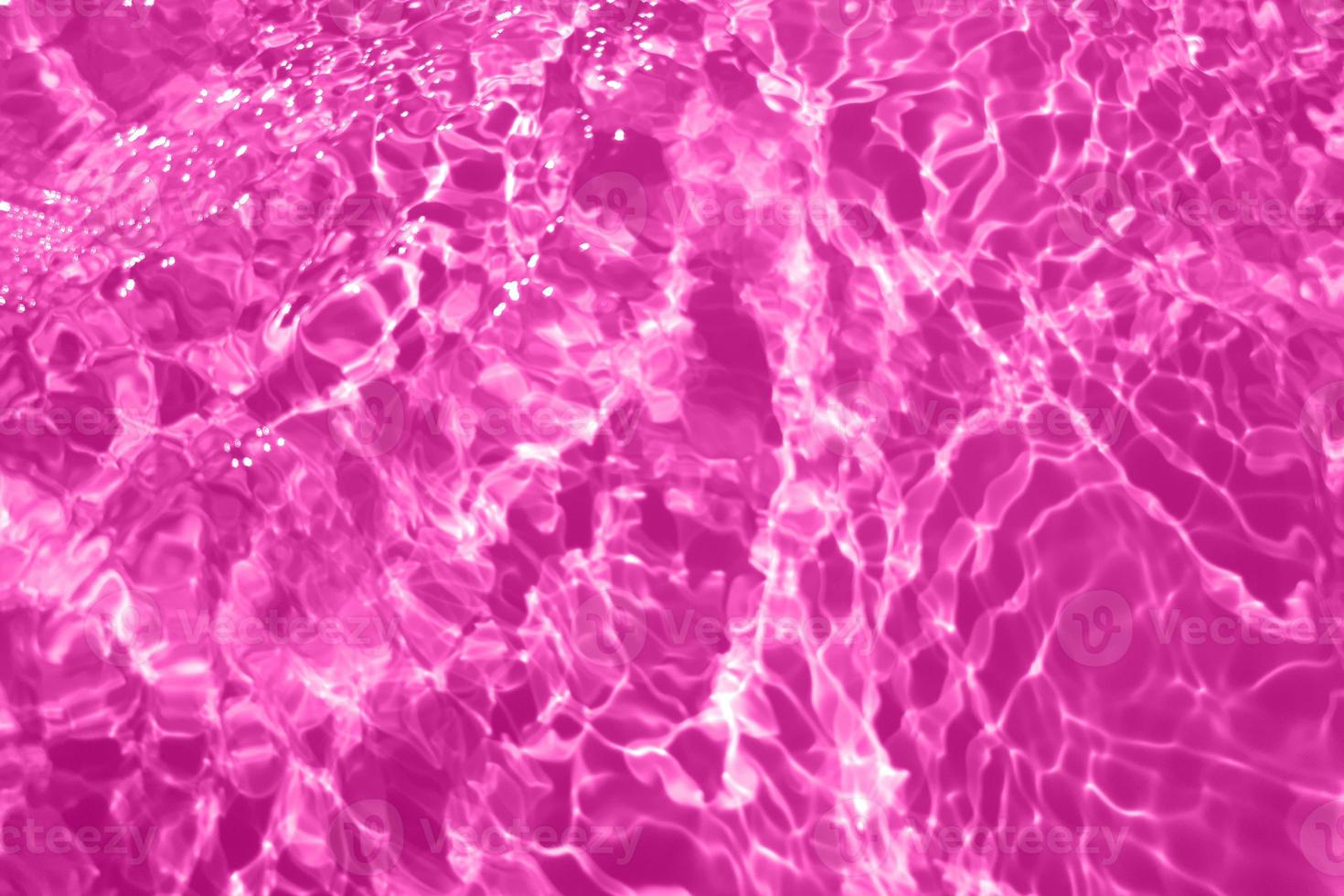 Defocus blurred transparent purple colored clear calm water surface texture with splash, bubble. Shining purple water ripple background. Surface of water in swimming pool. Purple bubble water shine. photo