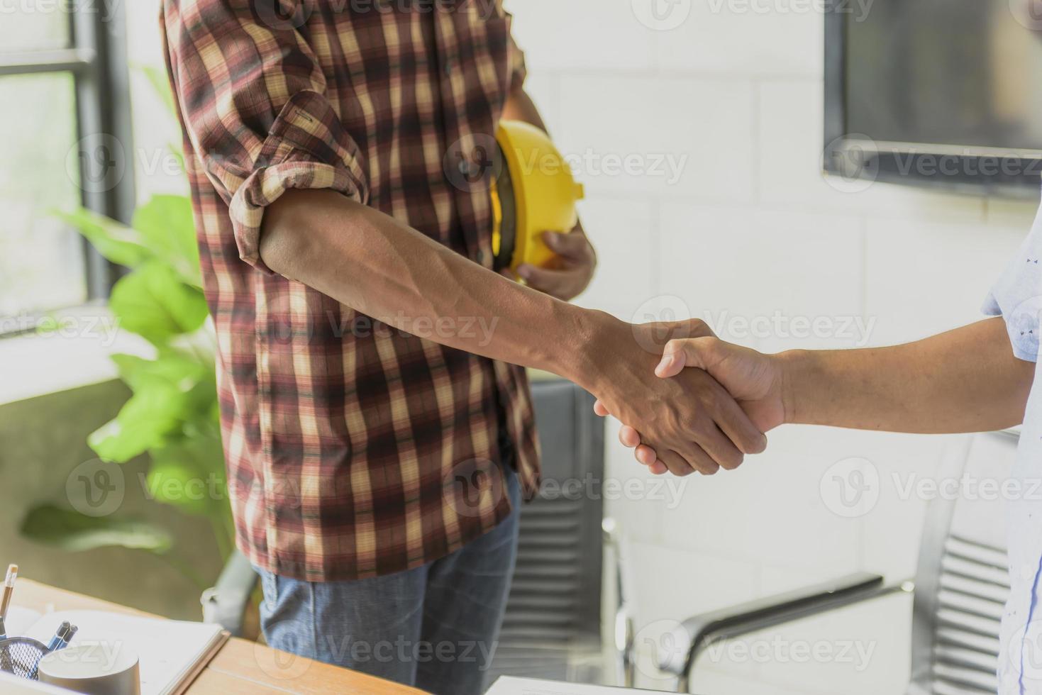 Businessmen join hands to invest and share profits in real estate projects. photo