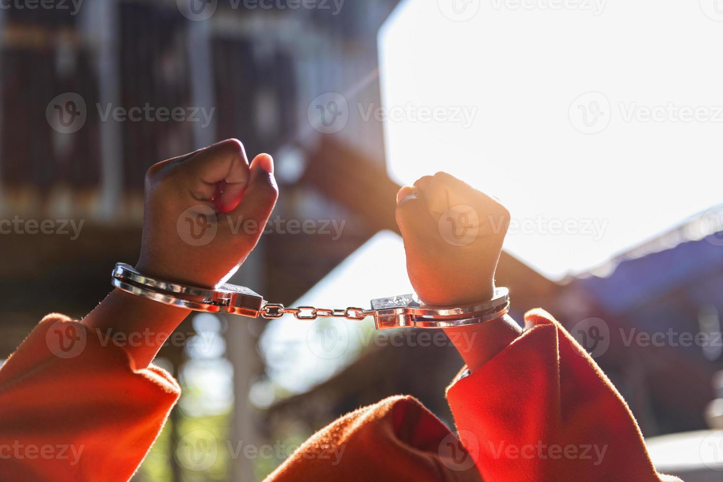 Desperate criminal man sitting on the floor in handcuffs. She arrested for robbery. photo