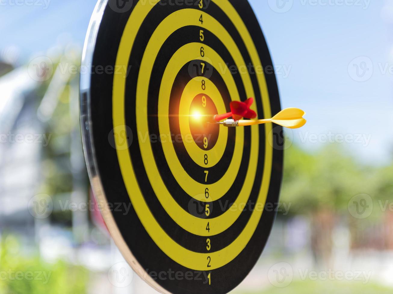 Two dart hit it's target on a red background, concept for success,darts motion blur. photo