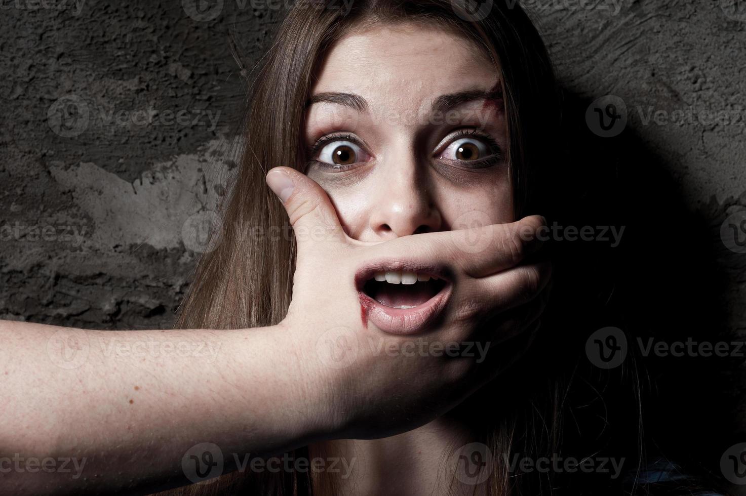 No Terrified young woman with hand covering her mouth staring at camera photo