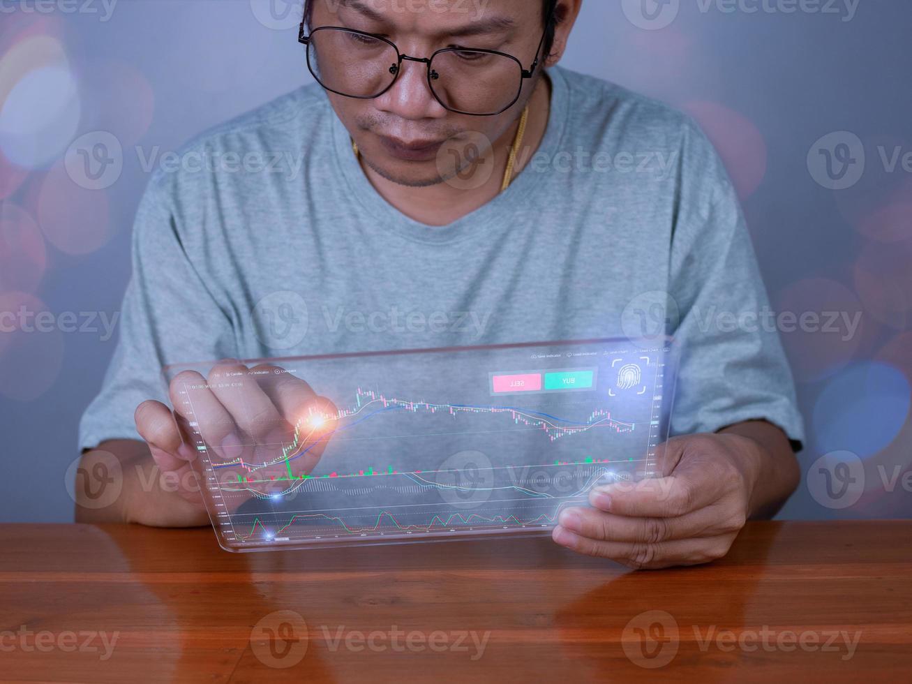 Hologram image of a candlestick chart from a tablet on a person hand. concept of stock trading and investment photo