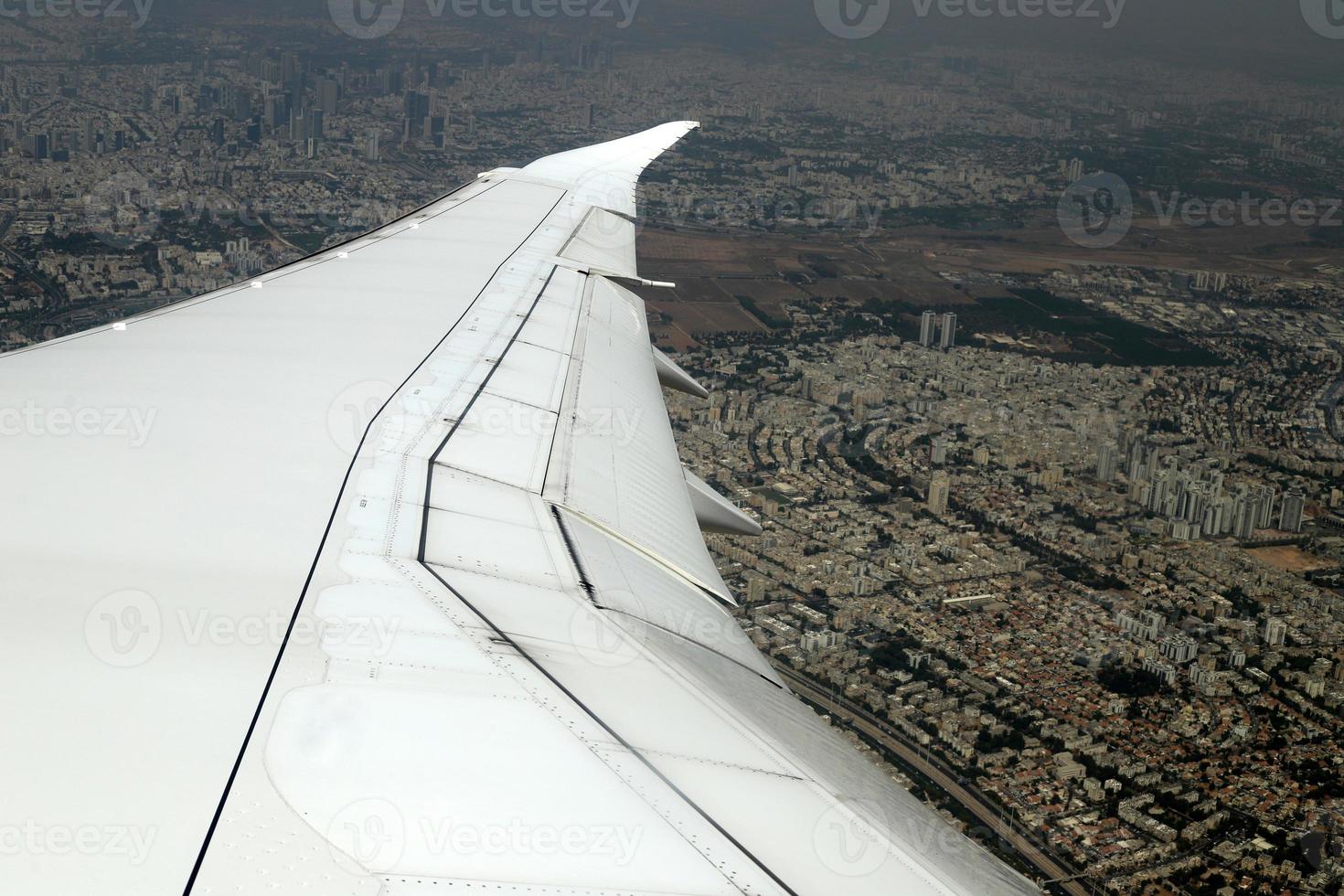 The earth is seen through the porthole of a large jet plane. photo