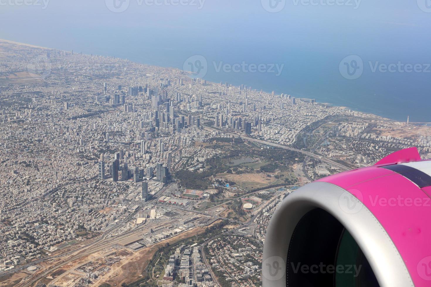 The earth is seen through the porthole of a large jet plane. photo