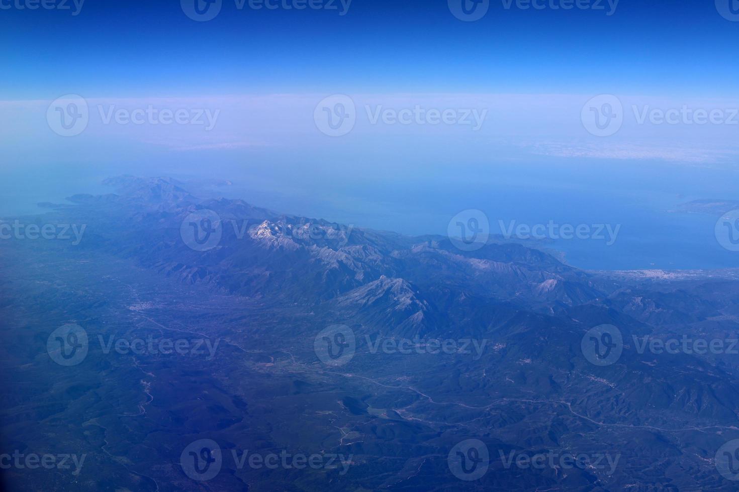 The earth is seen through the porthole of a large jet plane. photo