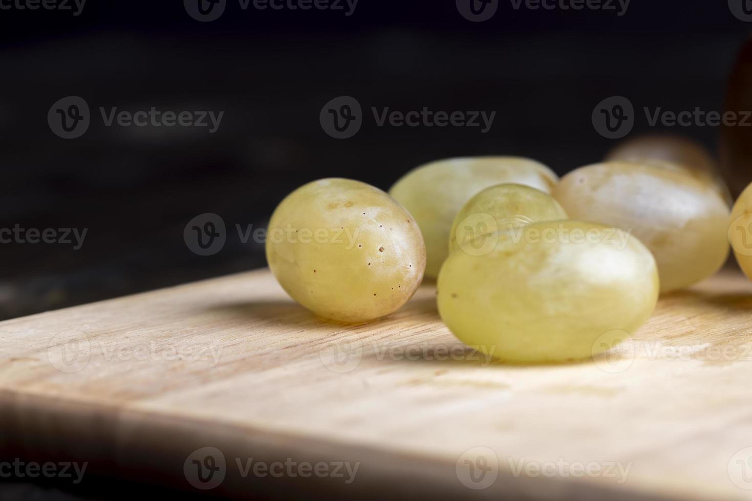 Homemade green unwashed grapes on a board photo