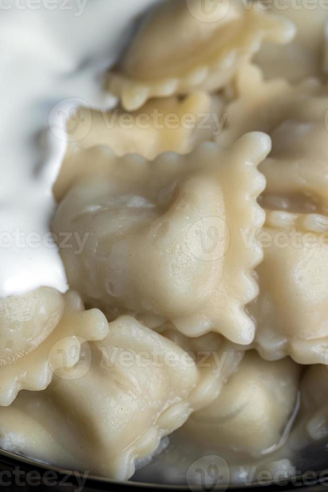 Sour cream covered dumplings with meat photo