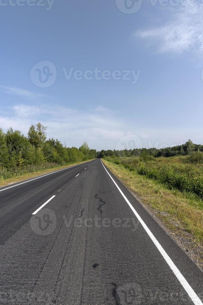 Narrow paved road for cars photo